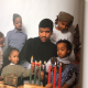 The author’s brother, Akhi (center), surrounded by family and friends in 2003 (John Pinderhughes)